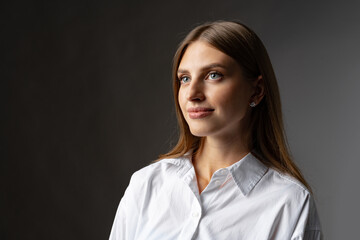 Fototapeta premium Thoughtful businesswoman portrait on a dark gray background