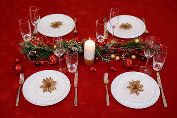 Christmas holidays table setting concept - champagne glasses and tableware for festive dinner
