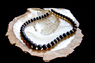 White and black pearls on white background.