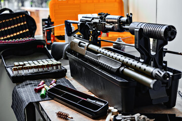 Shotgun rifle with cartridges on table in a weapon workshop
