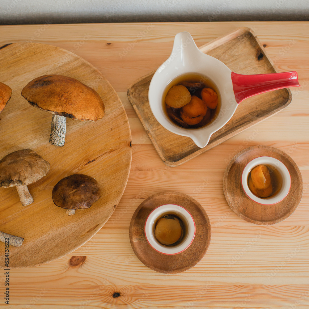 Wall mural mushrooms are lying on a wooden table