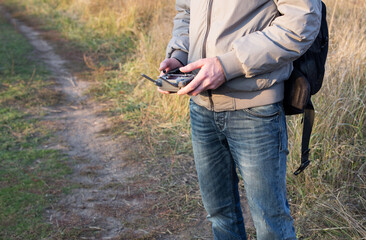 Fototapeta premium A man holds a drone control panel in his hands close-up.