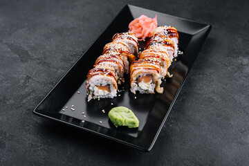 Sushi eel roll maki on black plate