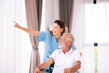 Fototapeta premium Beautiful nurse take care to senior men sitting on wheelchair in a nursing home