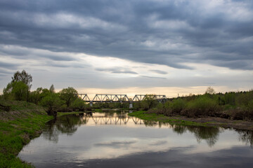 Spring landscape, dramatic sky over the river. View of the river in the evening.