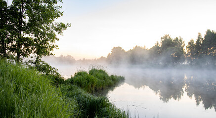 Obraz premium Fog in the early morning. Dawn by the river.