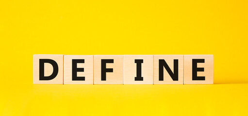 Define symbol. Concept word Define on wooden cubes. Beautiful yellow background. Business and Define concept. Copy space.