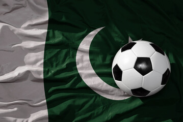 vintage football ball on the waveing national flag of pakistan background. 3D illustration - obrazy, fototapety, plakaty