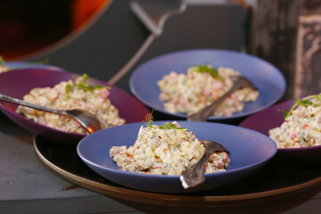 plates with russian salad close up photo ready for service