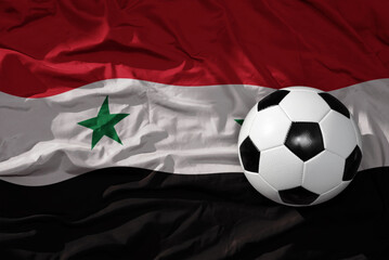 vintage football ball on the waveing national flag of syria background. 3D illustration