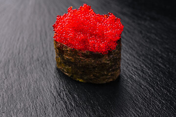 gunkan maki with caviar on black © AntAlexStudio