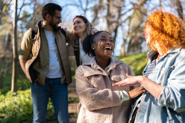 Friends walking in the nature, talking and smiling
Afro american models