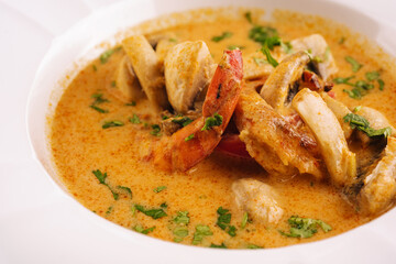 Shrimps tom yam kung in white bowl with thai spices