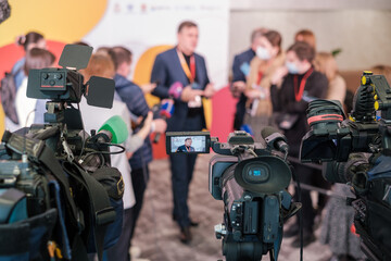 Cameras shooting journalists and businessman