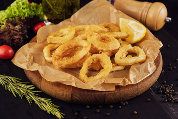 Oven baked breaded calamari rings served with lemon