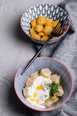 boiled and fried dumplings with sour cream and herbs