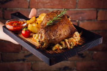 Fresh roasted pork knuckle with baked potatoes