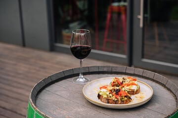 Bruschetta caponata with a glass of wine on the bar terrace
