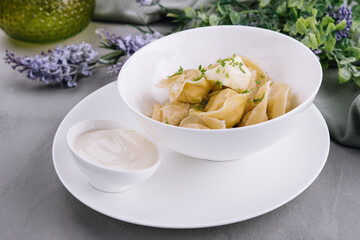 Delicious cooked dumplings with sour cream