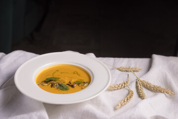 pumpkin soup on a light background, healthy food concept