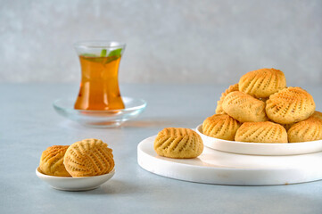 Traditional  arabic semolina maamoul or mamoul cookies with dates , walnuts and pistachio nuts . Closeup