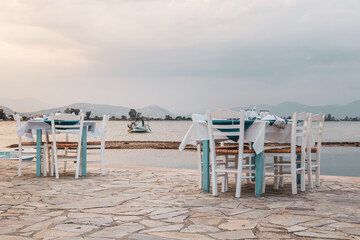 Seaside restaurant tables and chairs in Greece
