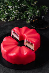 Multi layered raspberry mousse cake on plate