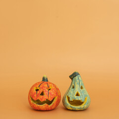 Colourful halloween pumpkins on orange background with copy space. Minimal autumn fall holidays concept