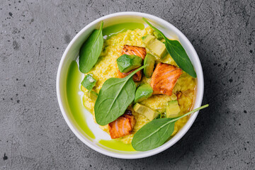 Scramble with avocado and pieces of salmon
