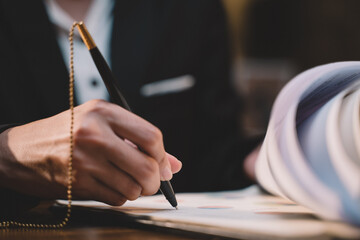 Businessman making agreement at office. it's a contract paper. Human hand holding pen mystery...