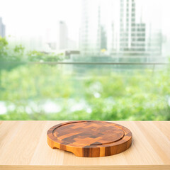 Chopping board on wood table and blurred garden park background