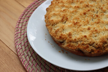 Traditional italian cake Sbrisolona made with walnuts and chocolate on a plate on wooden table