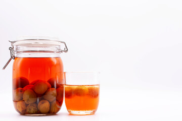 Glass jar of Japanese plum wine 'Umeshu'.Plum fruit mixed with vodka and sugar. The pickling period is 1 year.