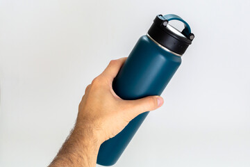 Man holding a blue thermos. white background.