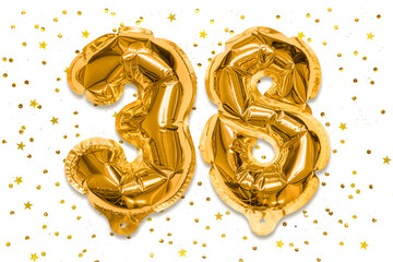The number of the balloon made of golden foil, the number thirty-eight on a white background with...
