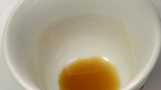 Vietnamese fish sauce running into a bowl