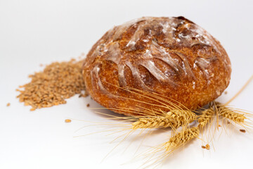Baked bread and wheat. White background.