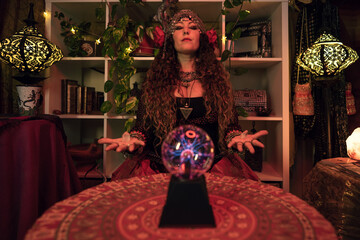 gypsy pythoness invoking the spirits of the dead with her magic crystal ball