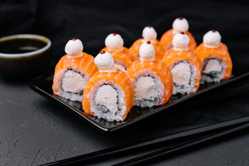 Salmon sushi with rice on black plate