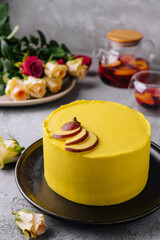yellow cake with tea and roses