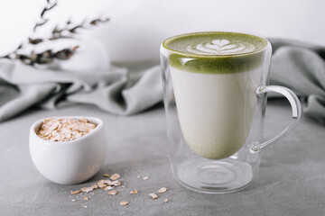 glass cup of fresh matcha latte and oatmeal