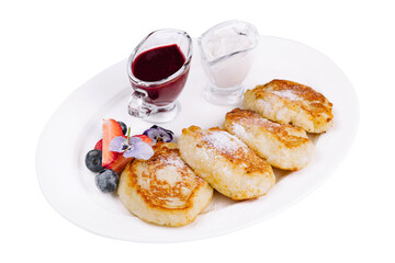 Cottage pancakes with berry jam, sour cream and berries