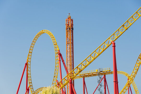 Yellow-red Roller Coaster And Free Fall Stella, Amusement Park View.