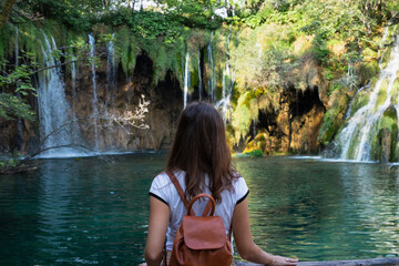 woman and a waterfall in Plitvice lakes national park