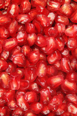 Ripe pomegranate seeds background. Many pomegranate seeds close up.