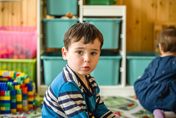 Small children boy and girl in the nursery