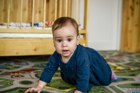 Little girl crawling on the floor.