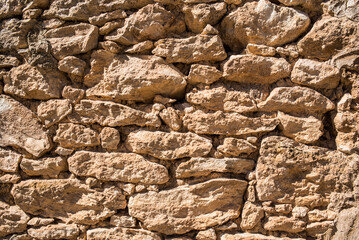 Old wall of stones and adobe in the south of Spain