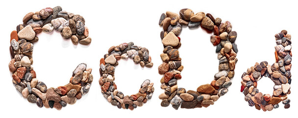 A letter of smooth stones on a white isolated background. Of the river stones lined with a letter, detailing, close-up. Selective focus
