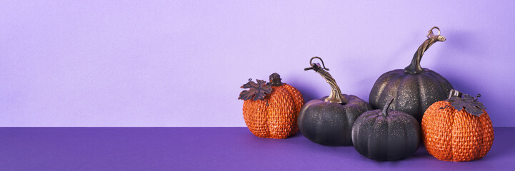 Halloween composition with pumpkins on violet banner. Greeting card template, Halloween decorations